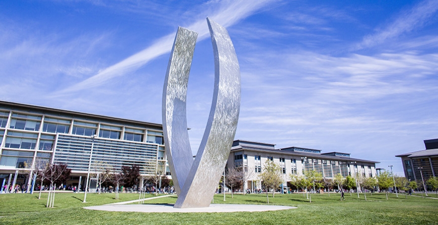 UC Merced's Beginnings sculpture in the middle of a grassy quad