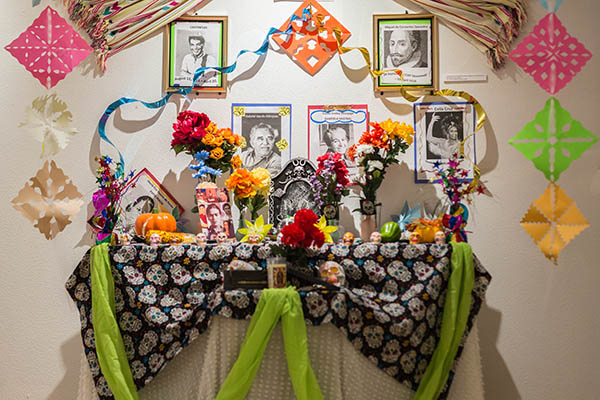 Altars are created to honor those who have passed and include photos of the deceased with items they loved.