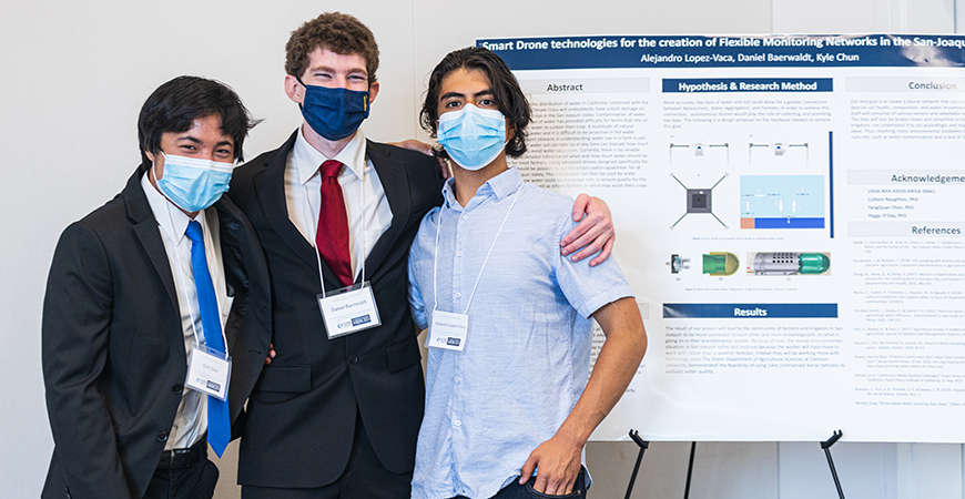Incoming freshman Kyle Chun (mechanical engineering), third-year Daniel Baerwaldt (chemistry) and first-year Alejandro Lopez-Vaca (engineering) in front of their presentation. 