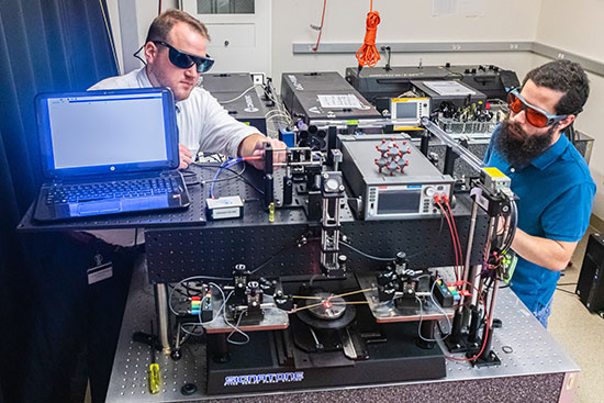 Men working in a physics lab